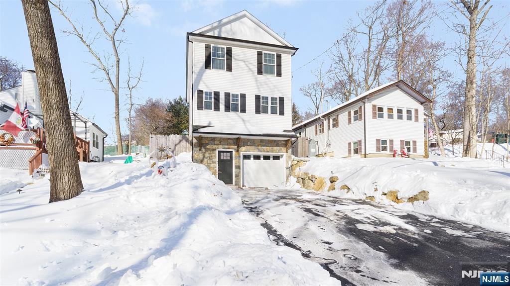 506 Brooklyn Mountain Road Hopatcong, NJ 07843 - Photo 21 of 30 a view of a white house with a yard covered in snow