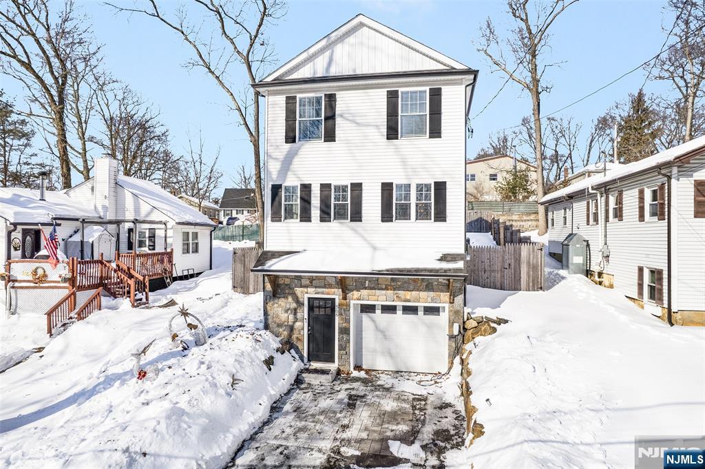 506 Brooklyn Mountain Road Hopatcong, NJ 07843 - Photo 3 of 30 a front view of a house with a yard covered with snow