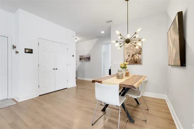 a view of a dining room with furniture and a chandelier