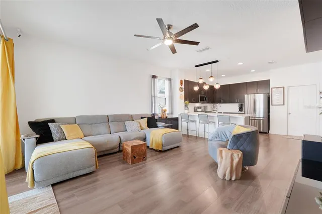 a living room with furniture and kitchen view