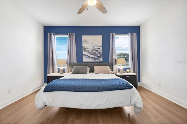 a bedroom with a large bed and a large window