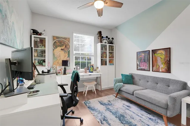 a living room with furniture a chandelier and a window
