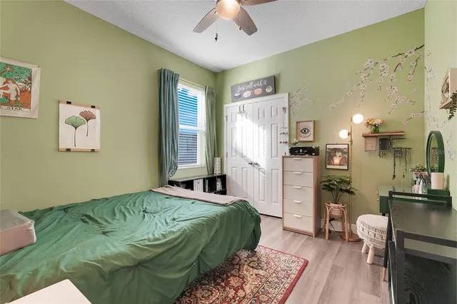 a bedroom with a bed and a chandelier