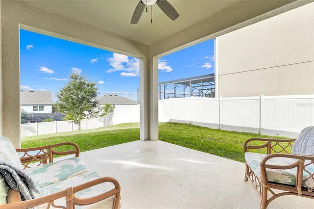 a view of a porch with furniture and garden