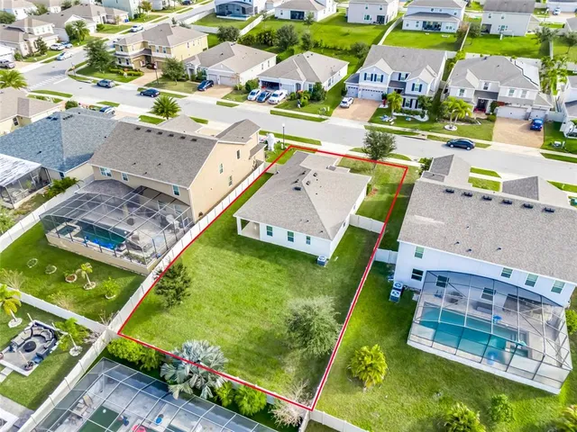 an aerial view of a house with a garden and swimming pool