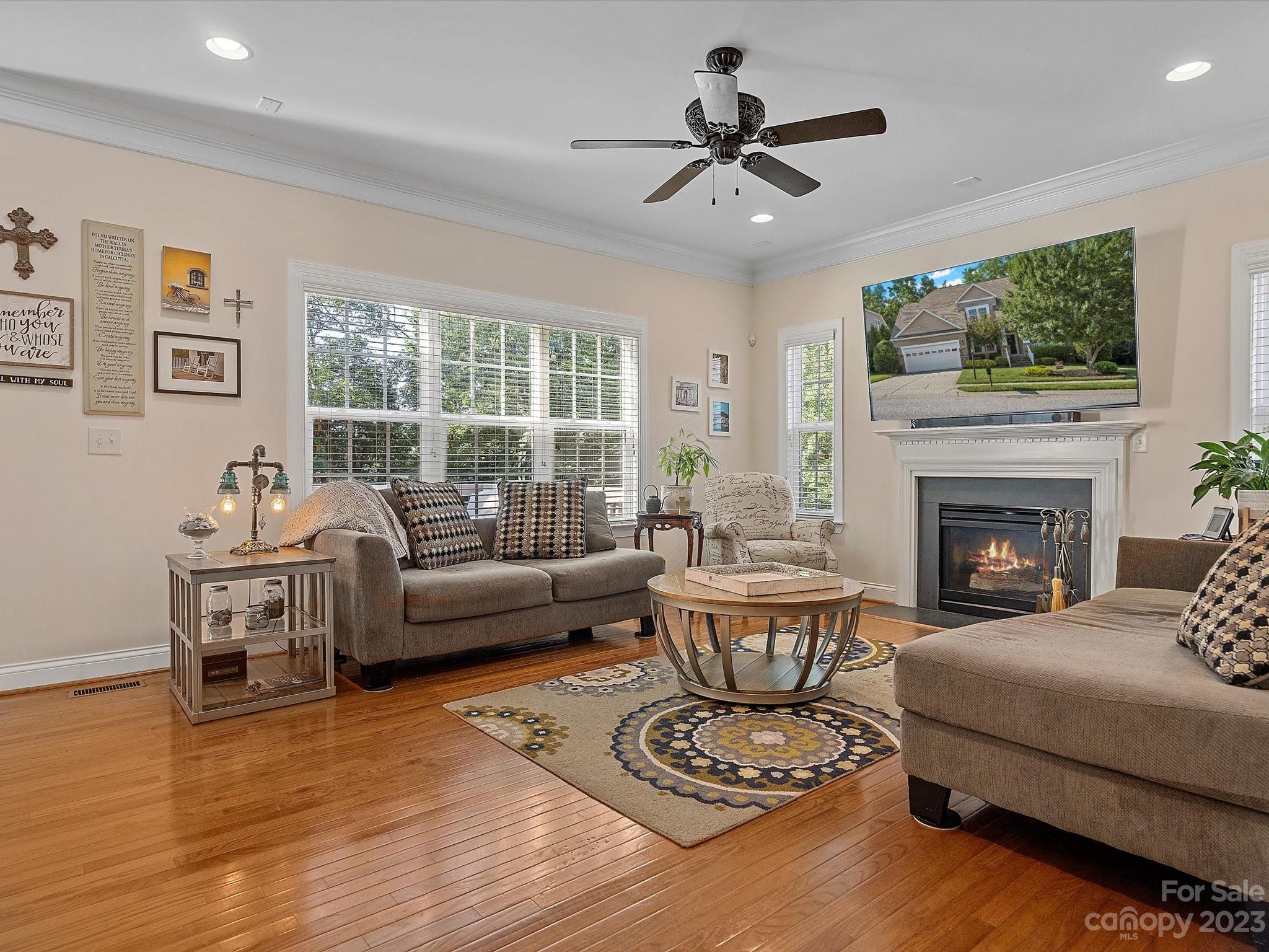 4136 Sunset Ridge Drive Rock Hill, SC 29732 - Photo 12 of 44 a living room with furniture a fireplace and a flat screen tv