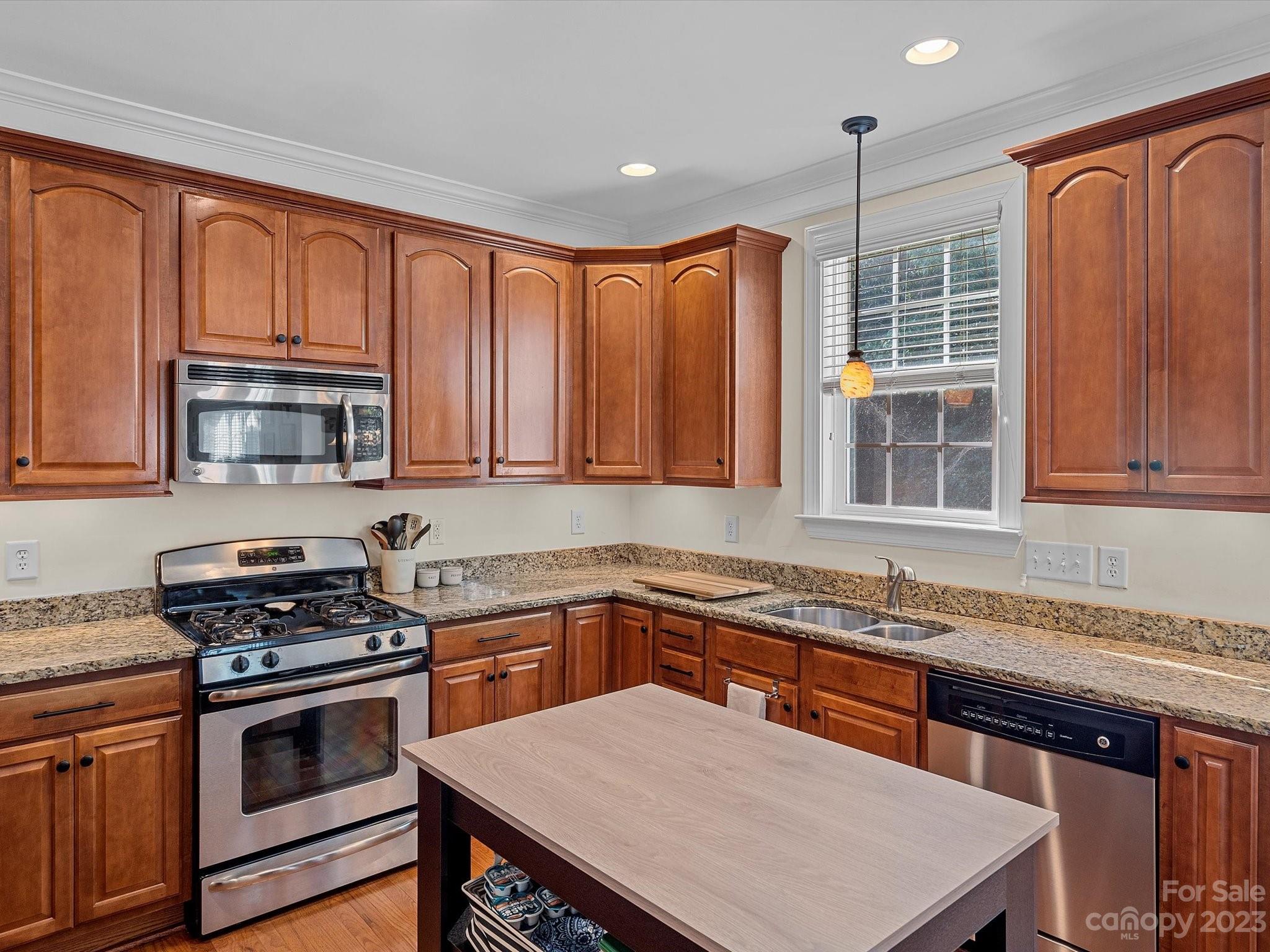 4136 Sunset Ridge Drive Rock Hill, SC 29732 - Photo 22 of 44 a kitchen with stainless steel appliances a stove sink microwave and cabinets