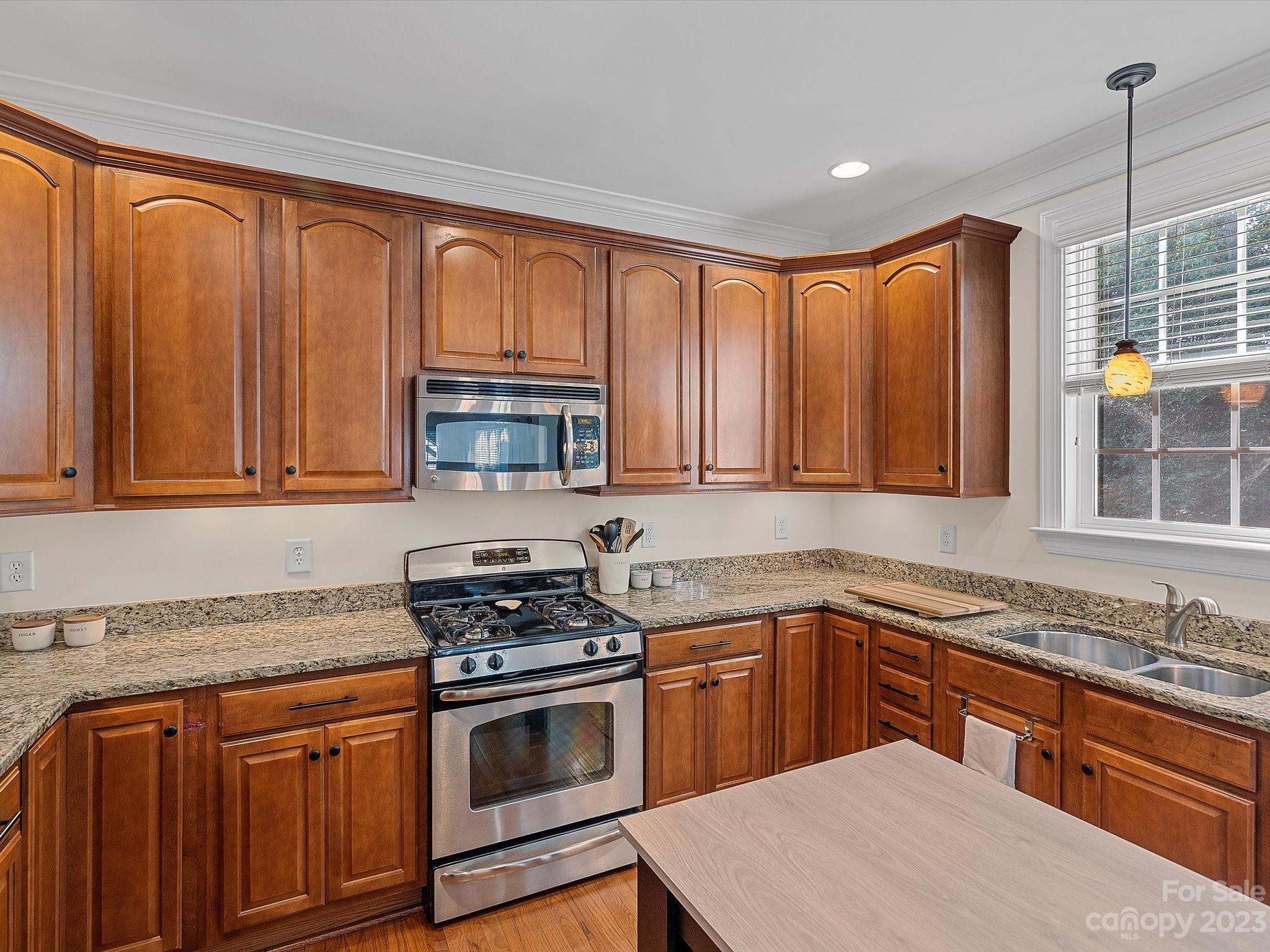 4136 Sunset Ridge Drive Rock Hill, SC 29732 - Photo 23 of 44 a kitchen with stainless steel appliances granite countertop a sink stove and microwave