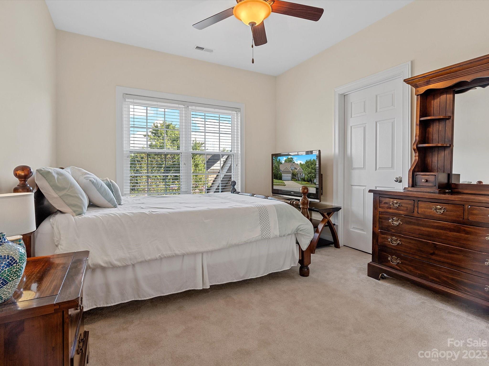 4136 Sunset Ridge Drive Rock Hill, SC 29732 - Photo 28 of 44 a bedroom with a bed and a chandelier