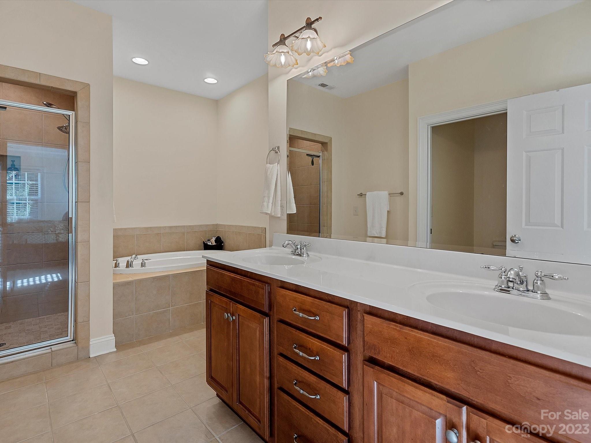 4136 Sunset Ridge Drive Rock Hill, SC 29732 - Photo 32 of 44 a spacious bathroom with a granite countertop sink a toilet a mirror and shower