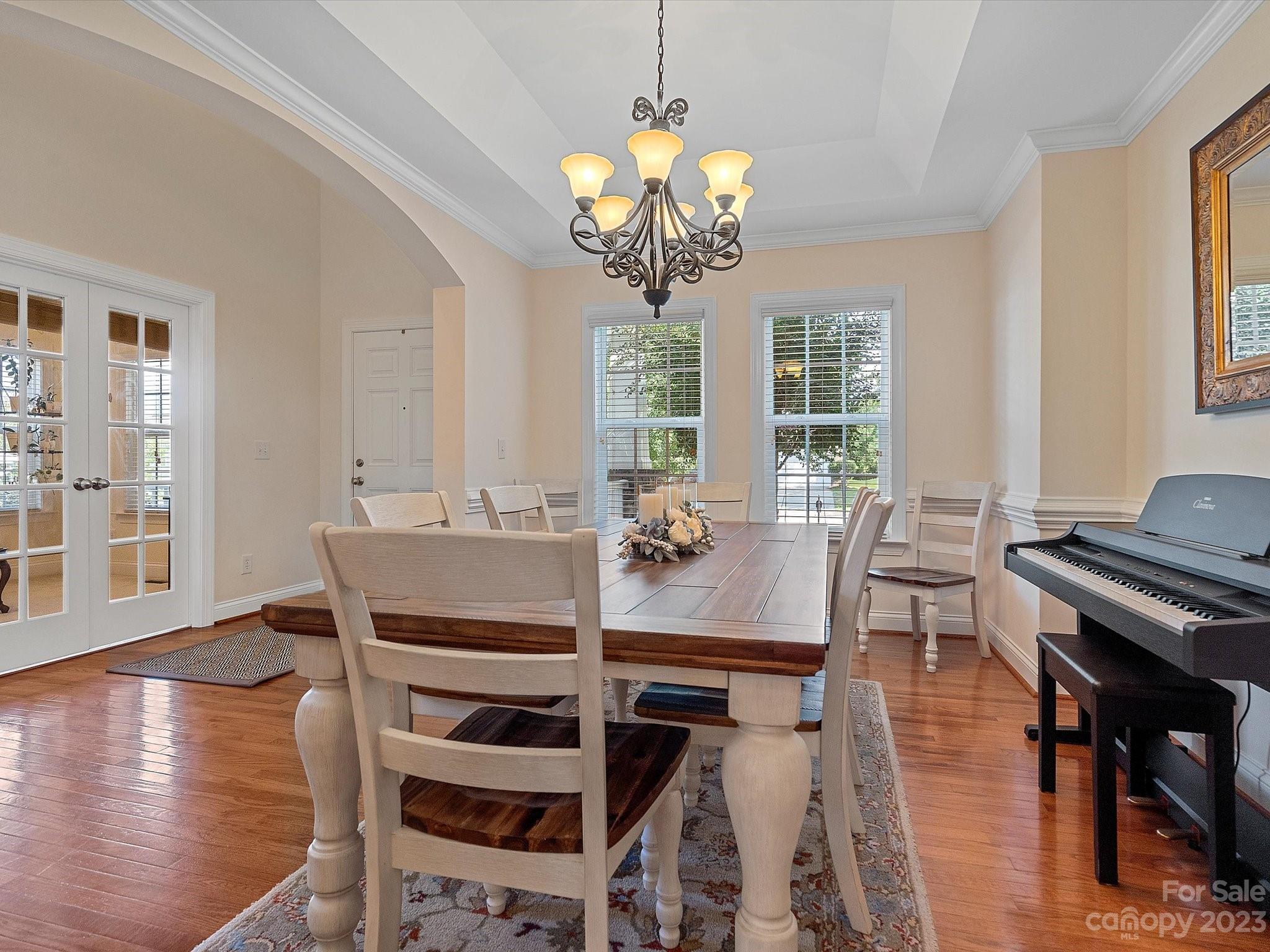 4136 Sunset Ridge Drive Rock Hill, SC 29732 - Photo 8 of 44 a view of a dining room with furniture a chandelier and wooden floor