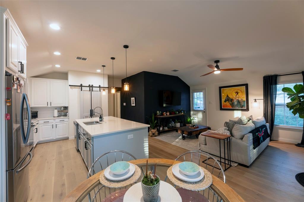 204 Main Street Haslet, TX 76052 - Photo 20 of 36 a living room with furniture a table and kitchen view