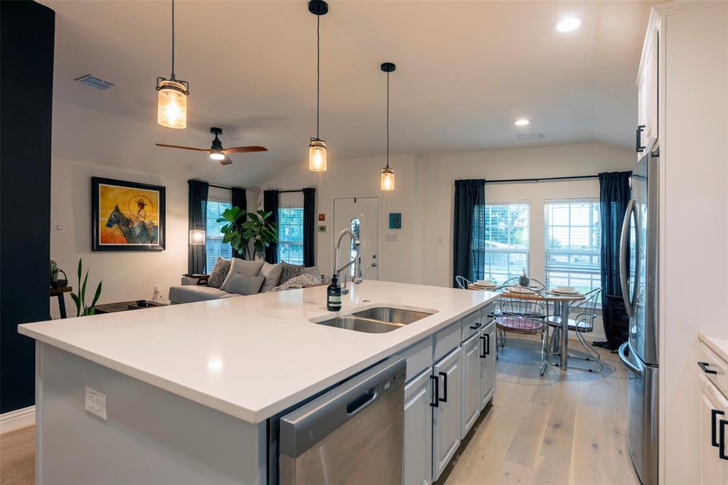 204 Main Street Haslet, TX 76052 - Photo 24 of 36 a large kitchen with kitchen island a island a sink a stove and a view of living room