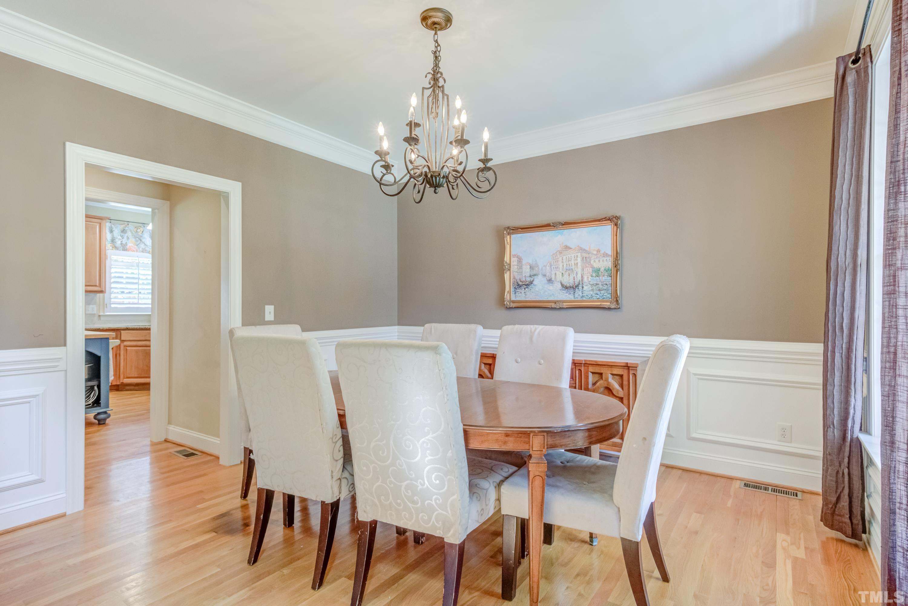11515 Azari Court Raleigh, NC 27614 - Photo 6 of 30 a view of a dining room with furniture wooden floor and a chandelier