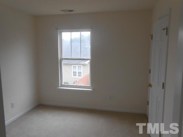 4113 Hopper Street Raleigh, NC 27616 - Photo 10 of 15 an empty room with a window