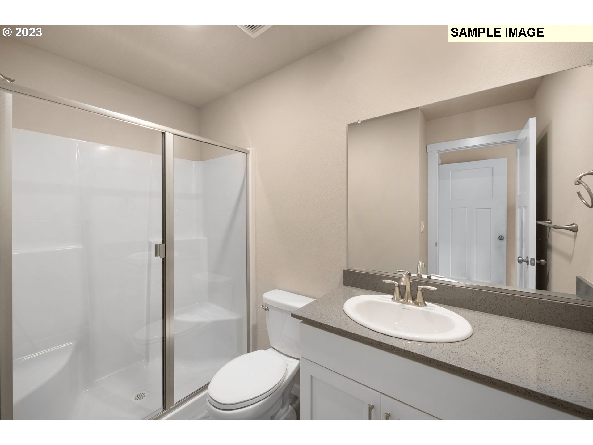 12011 Southeast High Creek Road, Unit C Happy Valley, OR 97086 - Photo 17 of 20 a bathroom with a sink toilet a mirror and shower