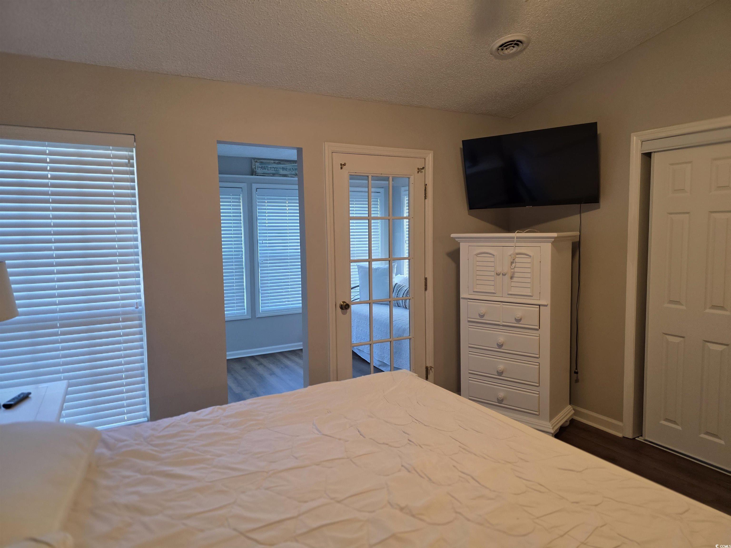 1637 Club Circle, Unit 18 Pawleys Island, SC 29585 - Photo 15 of 20 Bedroom with a textured ceiling, dark wood-type flooring, and lofted ceiling