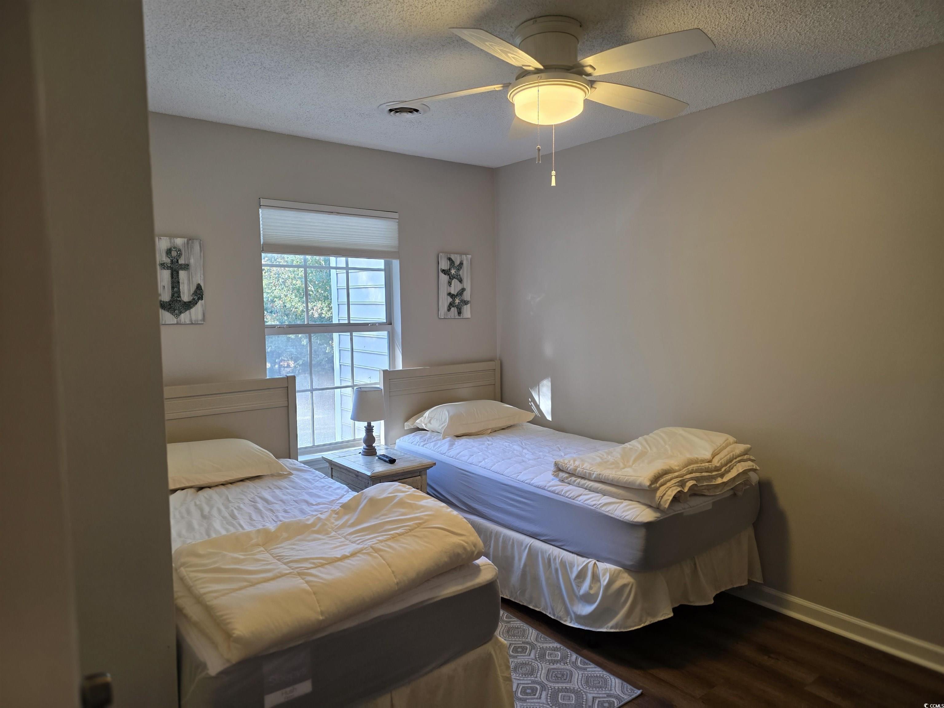 1637 Club Circle, Unit 18 Pawleys Island, SC 29585 - Photo 18 of 20 Bedroom featuring wood finished floors, a textured ceiling, and a ceiling fan