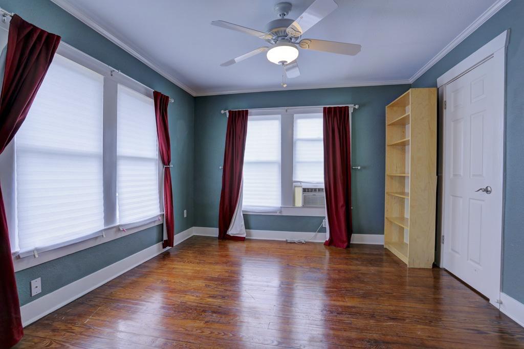 514 East 15th Street, Unit 2 Houston, TX 77008 - Photo 5 of 9 an empty room with wooden floor and windows