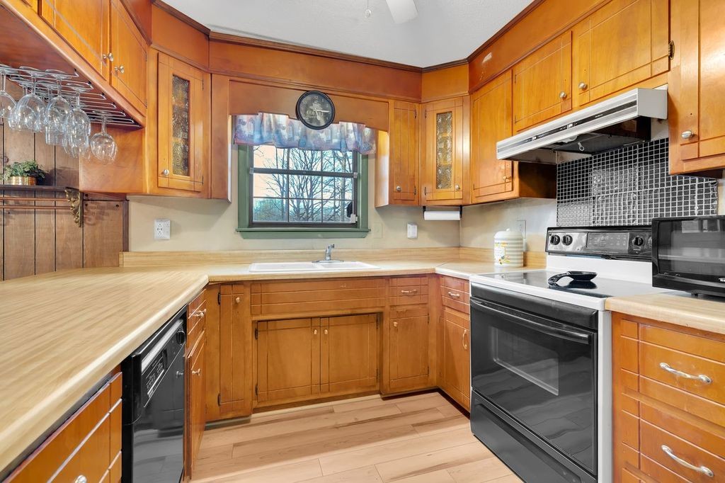 251 Bell Road Monteagle, TN 37356 - Photo 13 of 45 a kitchen with stainless steel appliances granite countertop a sink stove and cabinets