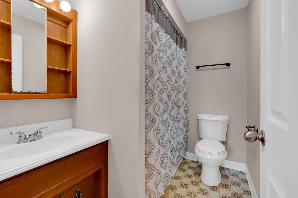 251 Bell Road Monteagle, TN 37356 - Photo 21 of 45 a white toilet sitting next to a bathroom sink
