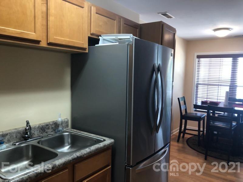 55 Derby Road, Unit 2D Cullowhee, NC 28723 - Photo 3 of 5 a kitchen with stainless steel appliances granite countertop a refrigerator and a sink