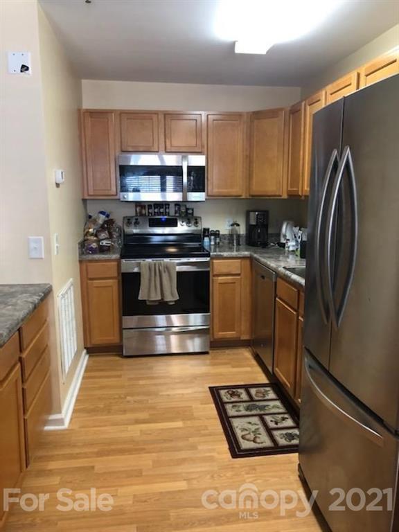 55 Derby Road, Unit 2D Cullowhee, NC 28723 - Photo 5 of 5 a kitchen with granite countertop a stove and a refrigerator