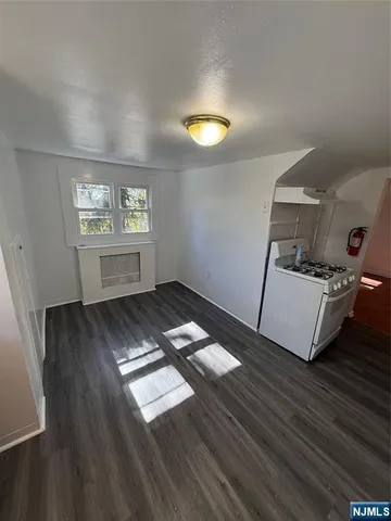 a view of a room with wooden floor and window