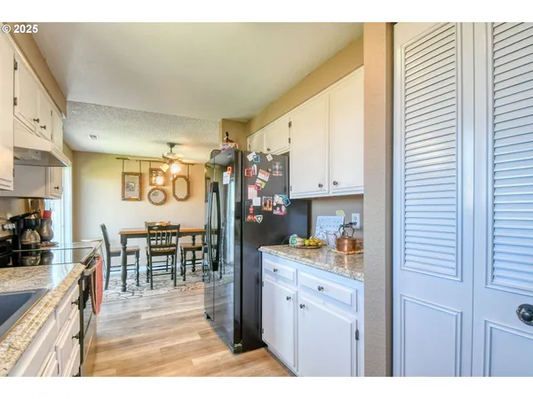 a kitchen with stainless steel appliances granite countertop a refrigerator and cabinets