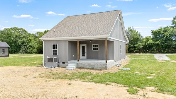 a view of house with outdoor space and sitting area