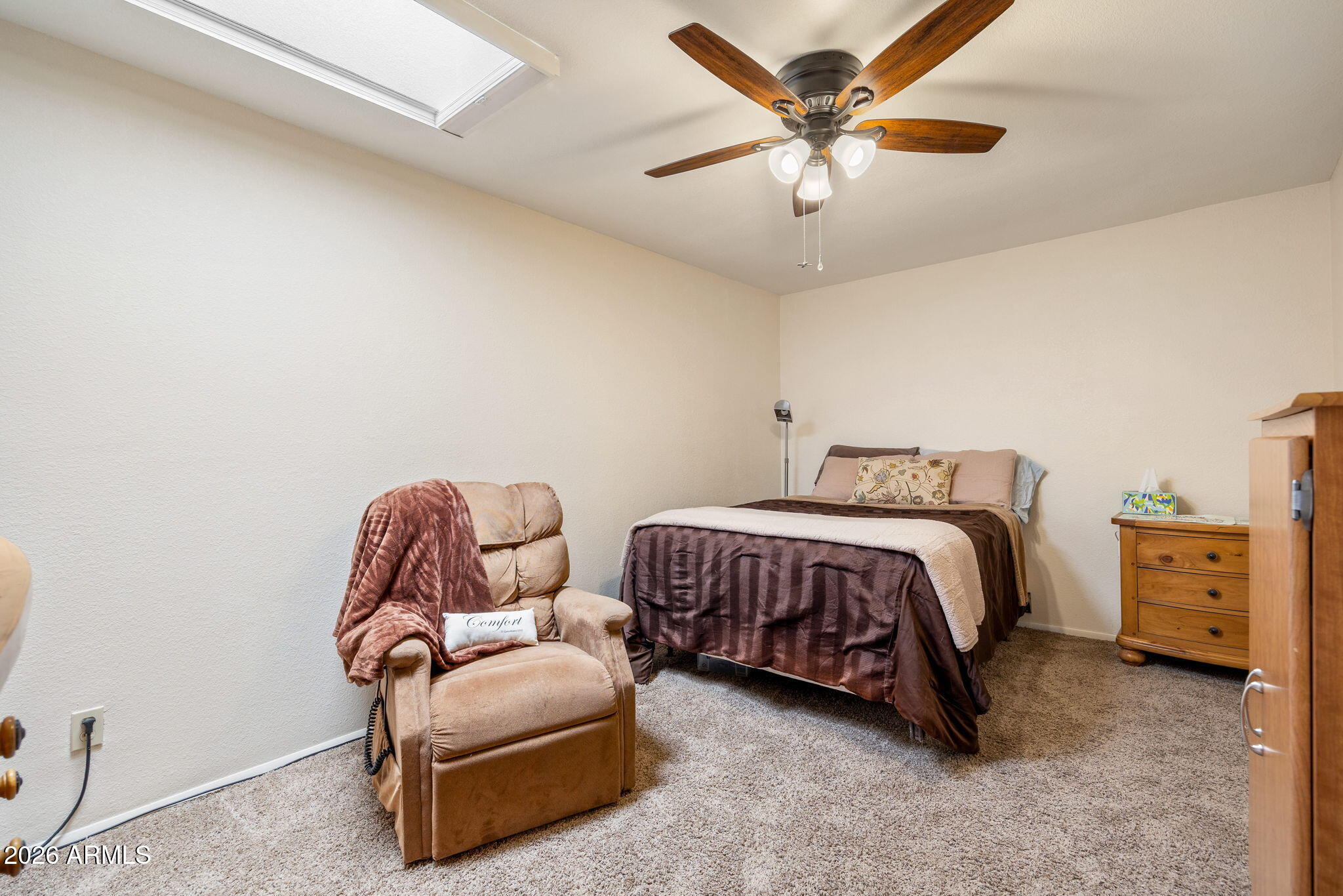 3384 Turkey Run Overgaard, AZ 85933 - Photo 22 of 37 a spacious bedroom with a bed and a chandelier