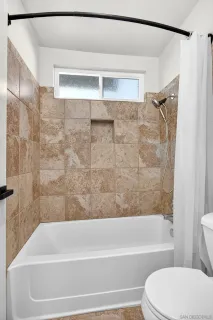a bathroom with a toilet and a bathtub