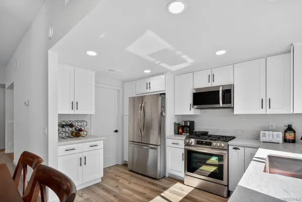 a kitchen with stainless steel appliances a refrigerator stove microwave and refrigerator