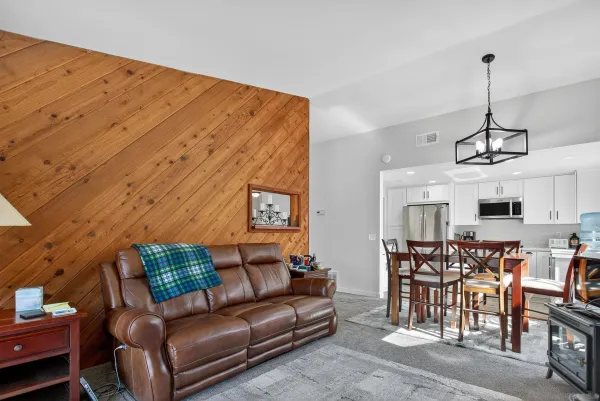 a living room with furniture and kitchen view
