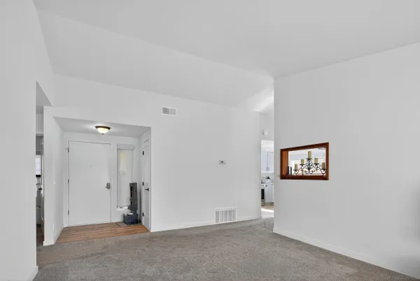 a view of an empty room with a bathroom