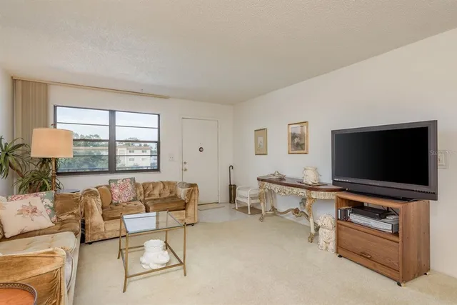 a view of a dining room with furniture and a chandelier