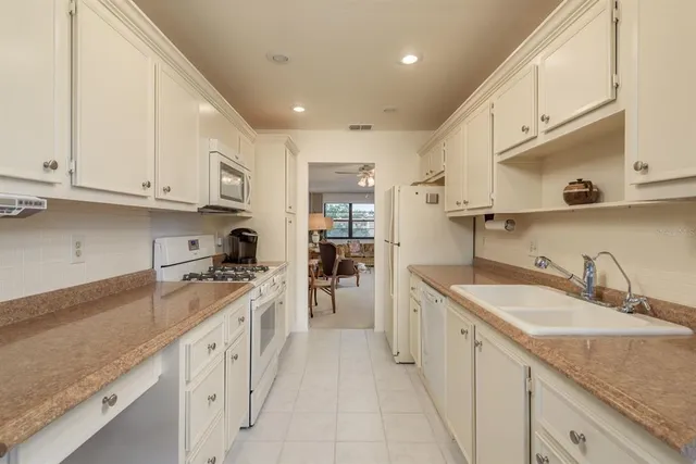a dining room with furniture and a floor to ceiling window