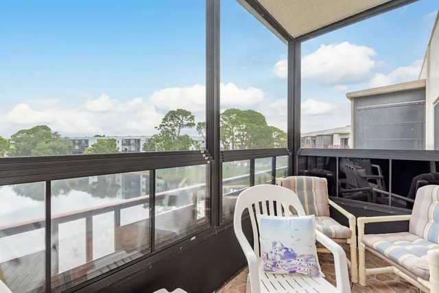 a view of a chairs and table in the balcony