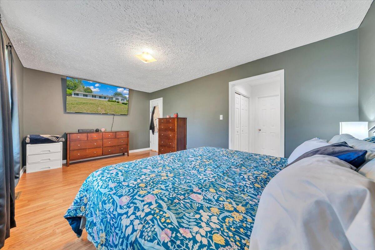 3870 Goose Dam Road Rocky Mount, VA 24151 - Photo 21 of 44 a bedroom with a bed and a flat screen television