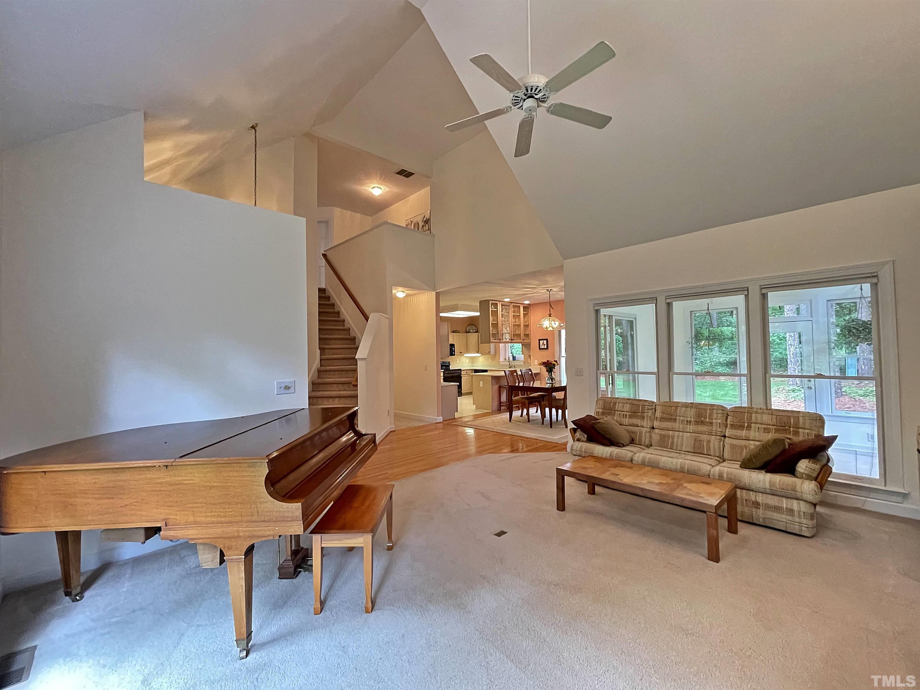 5437 Denberg Lane Raleigh, NC 27606 - Photo 18 of 45 a living room with furniture gym equipment and a large window