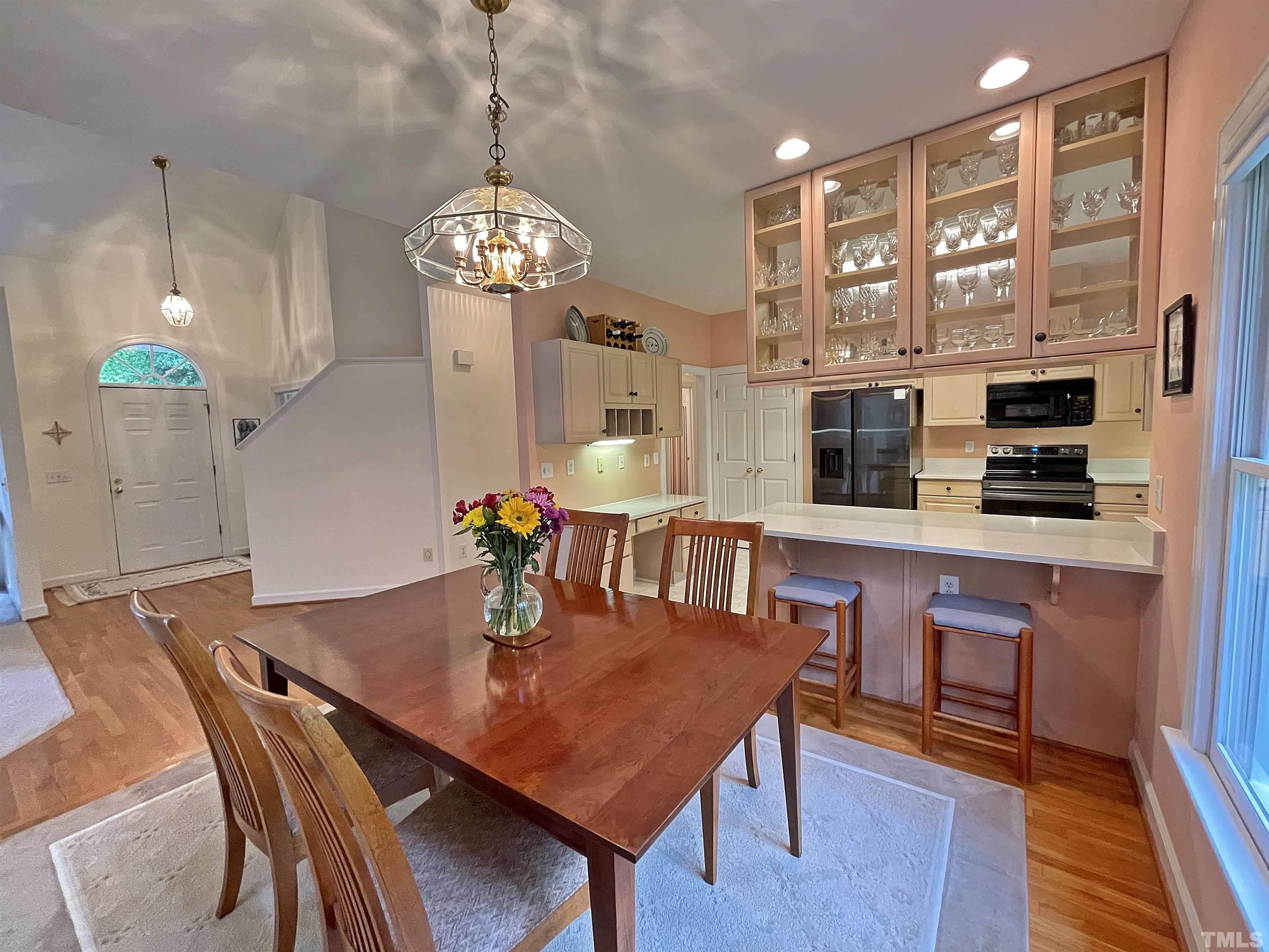 5437 Denberg Lane Raleigh, NC 27606 - Photo 20 of 45 a view of a dining room with furniture wooden floor and chandelier