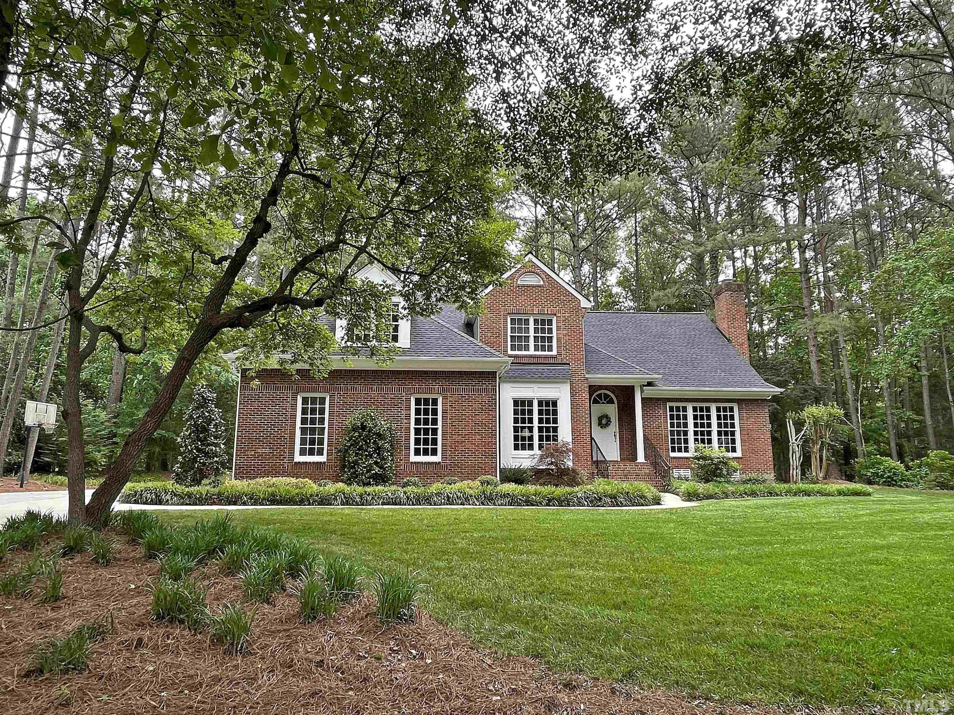 5437 Denberg Lane Raleigh, NC 27606 - Photo 2 of 45 a front view of a house with a garden