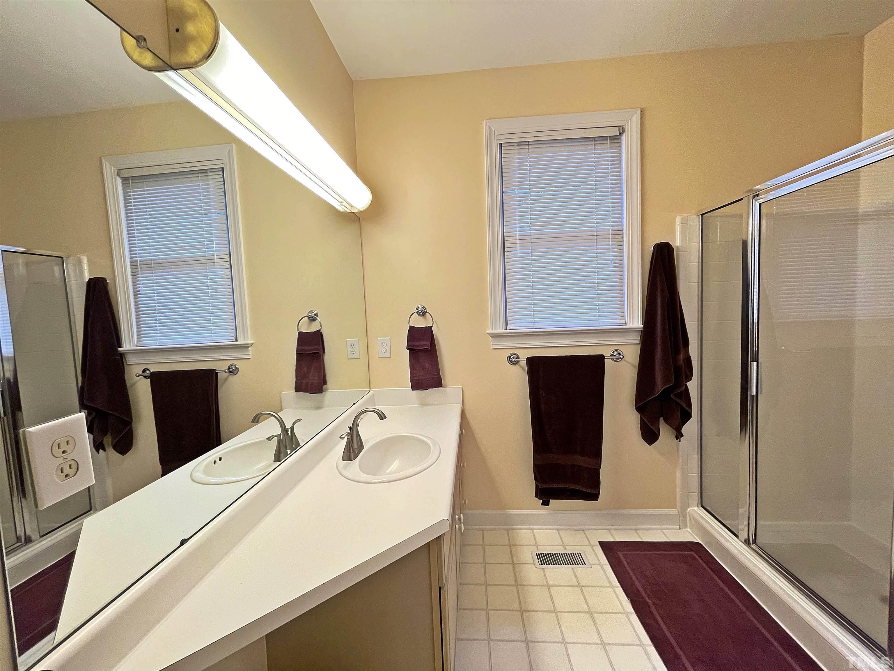 5437 Denberg Lane Raleigh, NC 27606 - Photo 33 of 45 a bathroom with a sink and a mirror