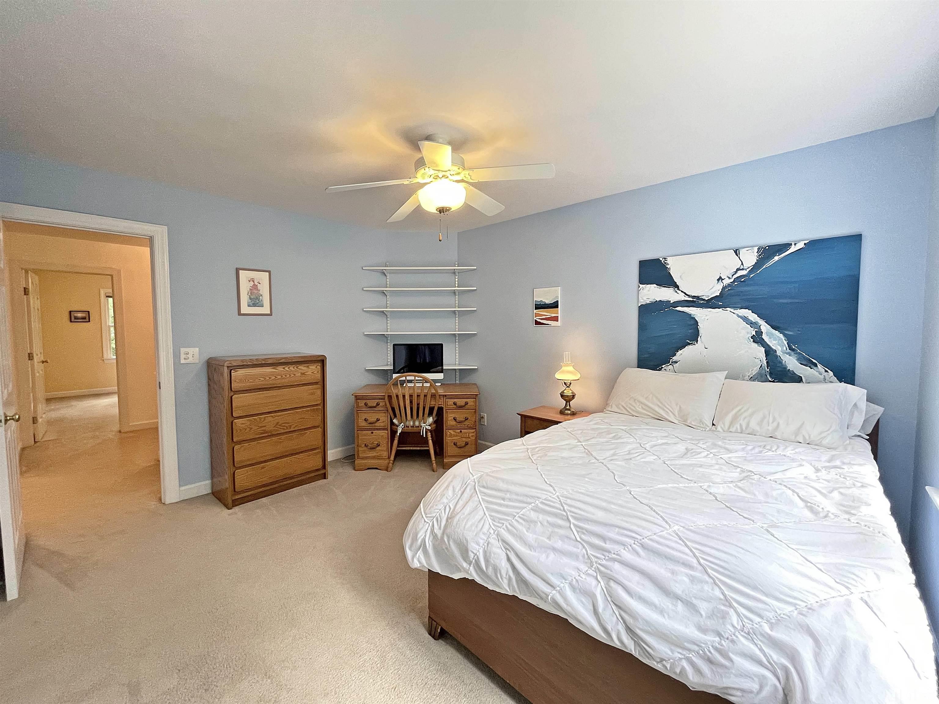 5437 Denberg Lane Raleigh, NC 27606 - Photo 38 of 45 a spacious bedroom with a bed and a chandelier