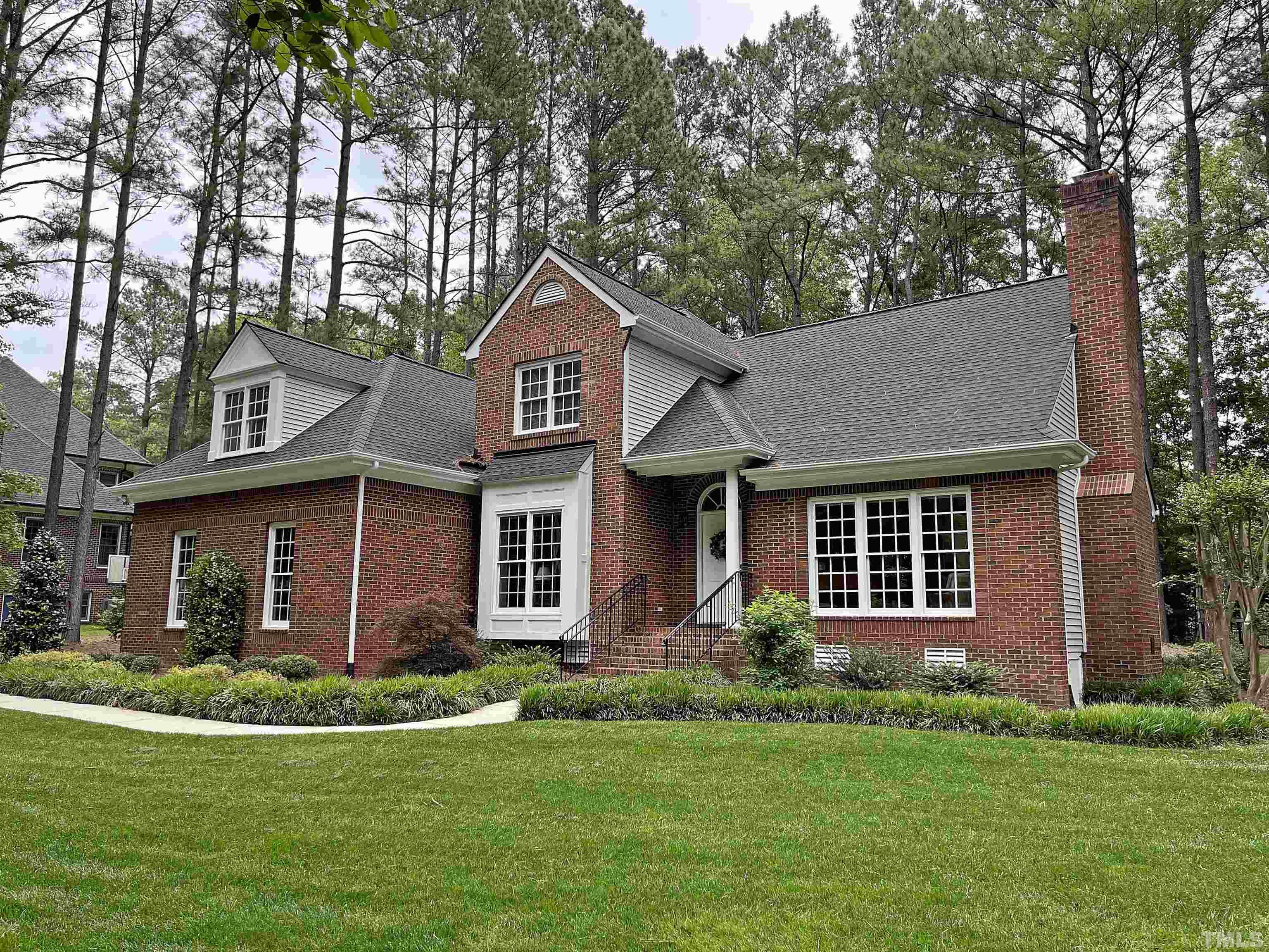 5437 Denberg Lane Raleigh, NC 27606 - Photo 4 of 45 a front view of a house with a yard and trees