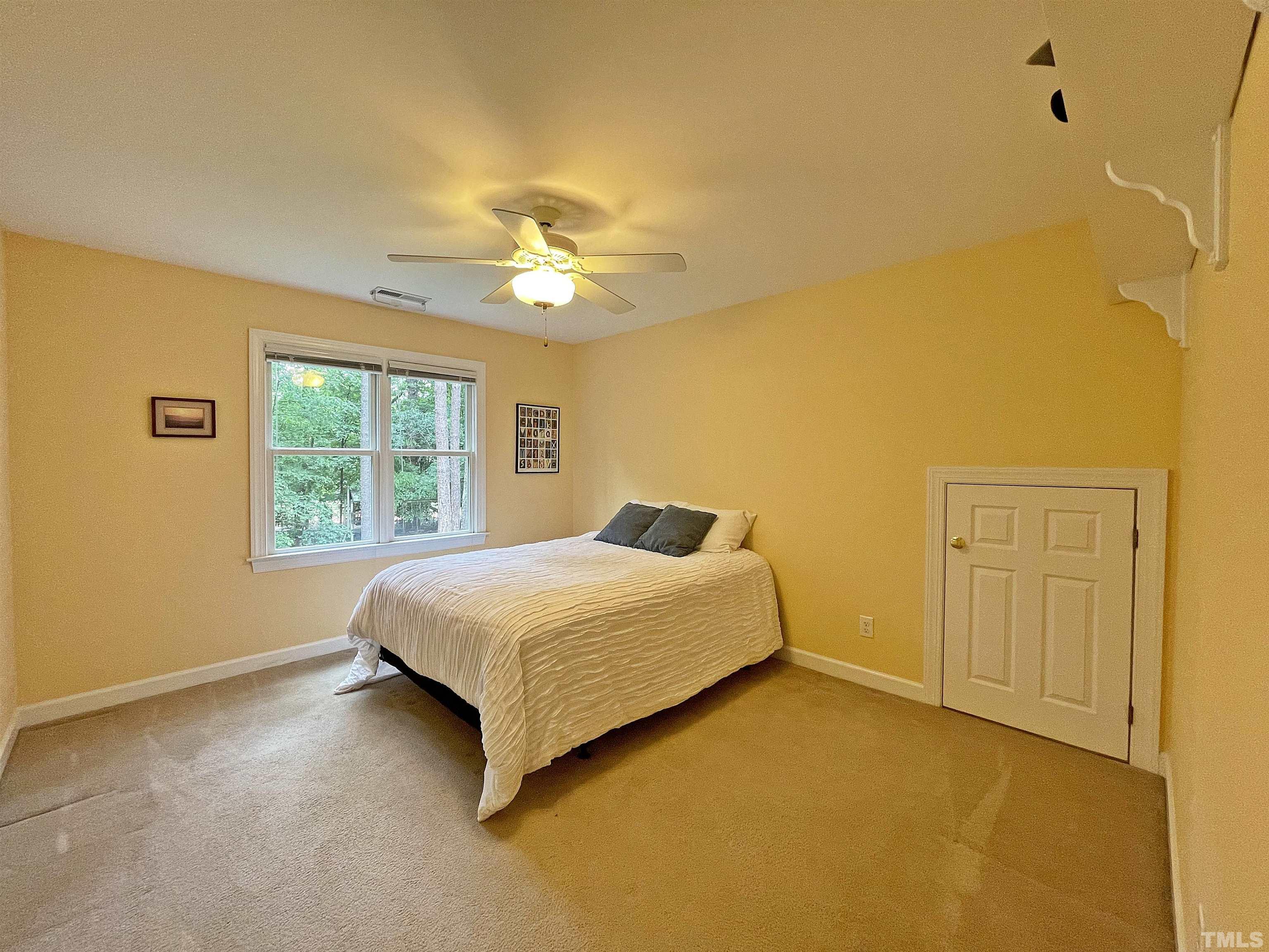 5437 Denberg Lane Raleigh, NC 27606 - Photo 41 of 45 a spacious bedroom with a bed and a window