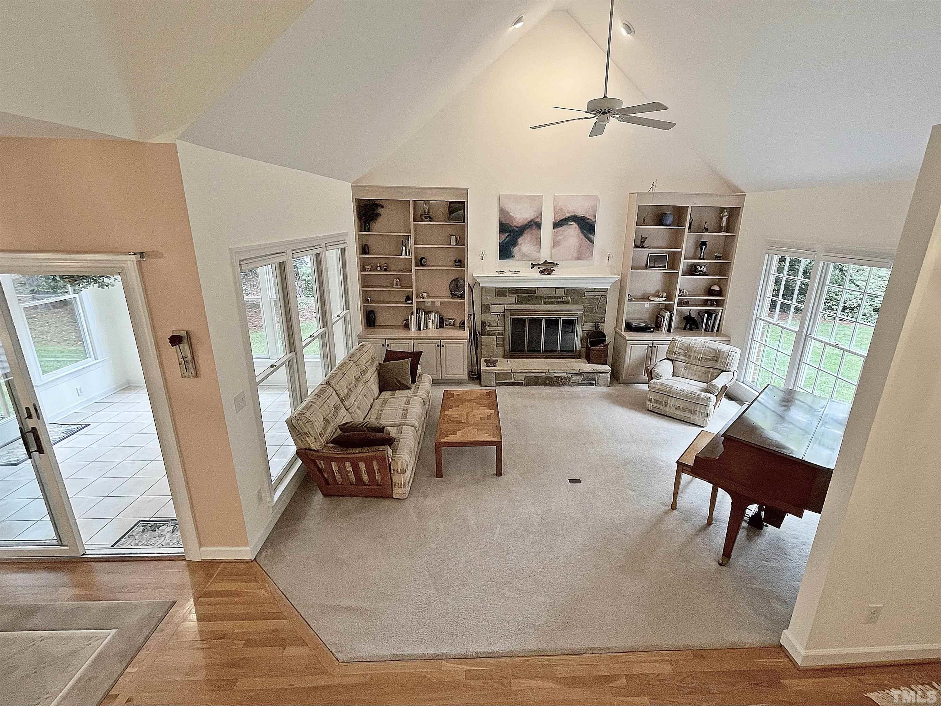 5437 Denberg Lane Raleigh, NC 27606 - Photo 43 of 45 a living room with furniture a fireplace and a large window