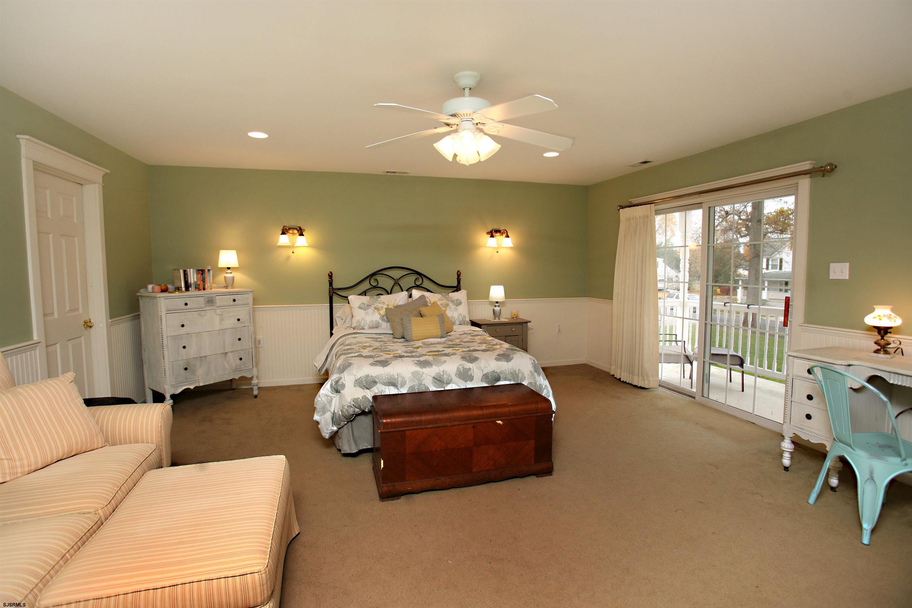 556 Grape Street Hammonton, NJ 08037 - Photo 13 of 26 a spacious bedroom with a bed and a chandelier