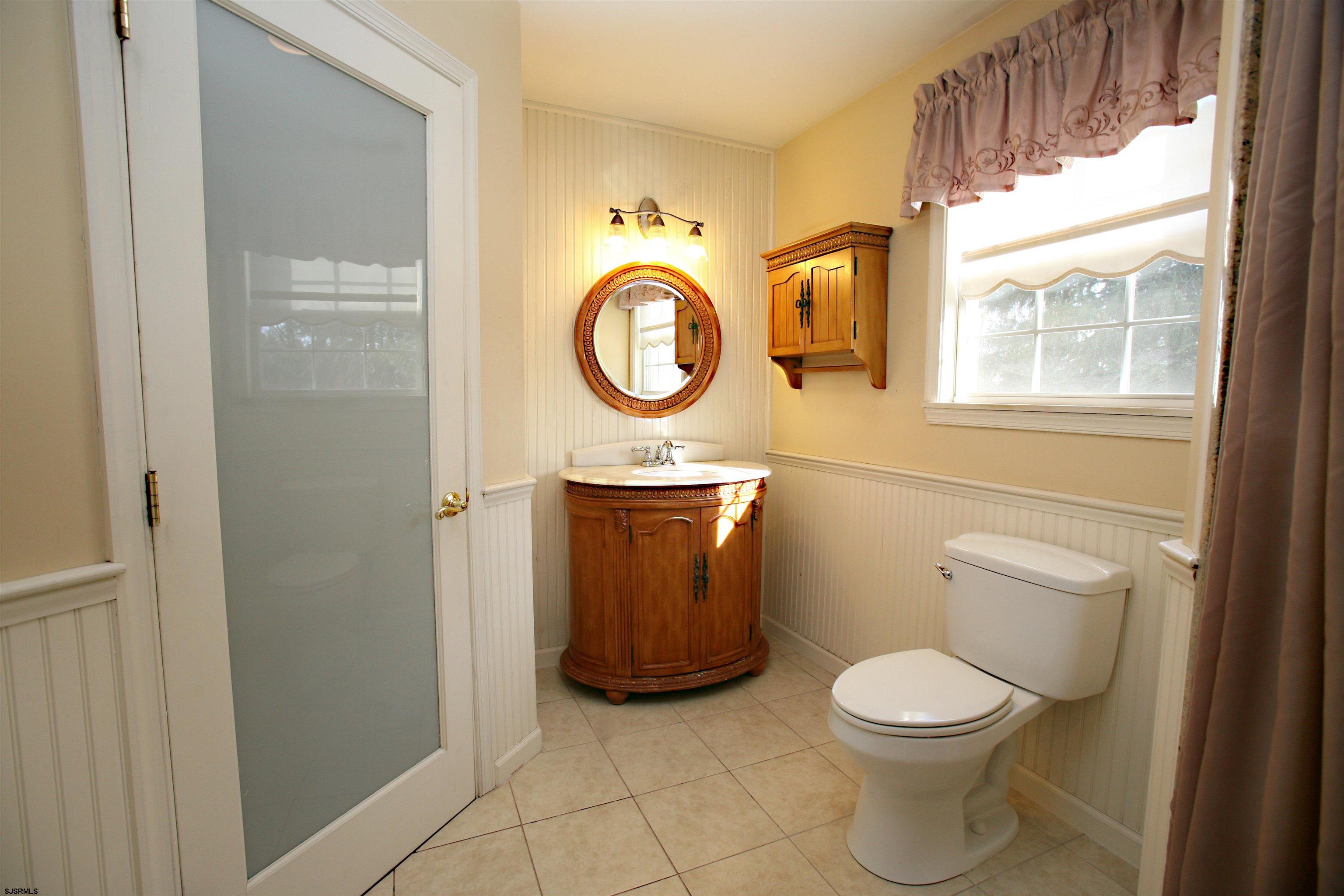 556 Grape Street Hammonton, NJ 08037 - Photo 15 of 26 a bathroom with a toilet a sink and a window