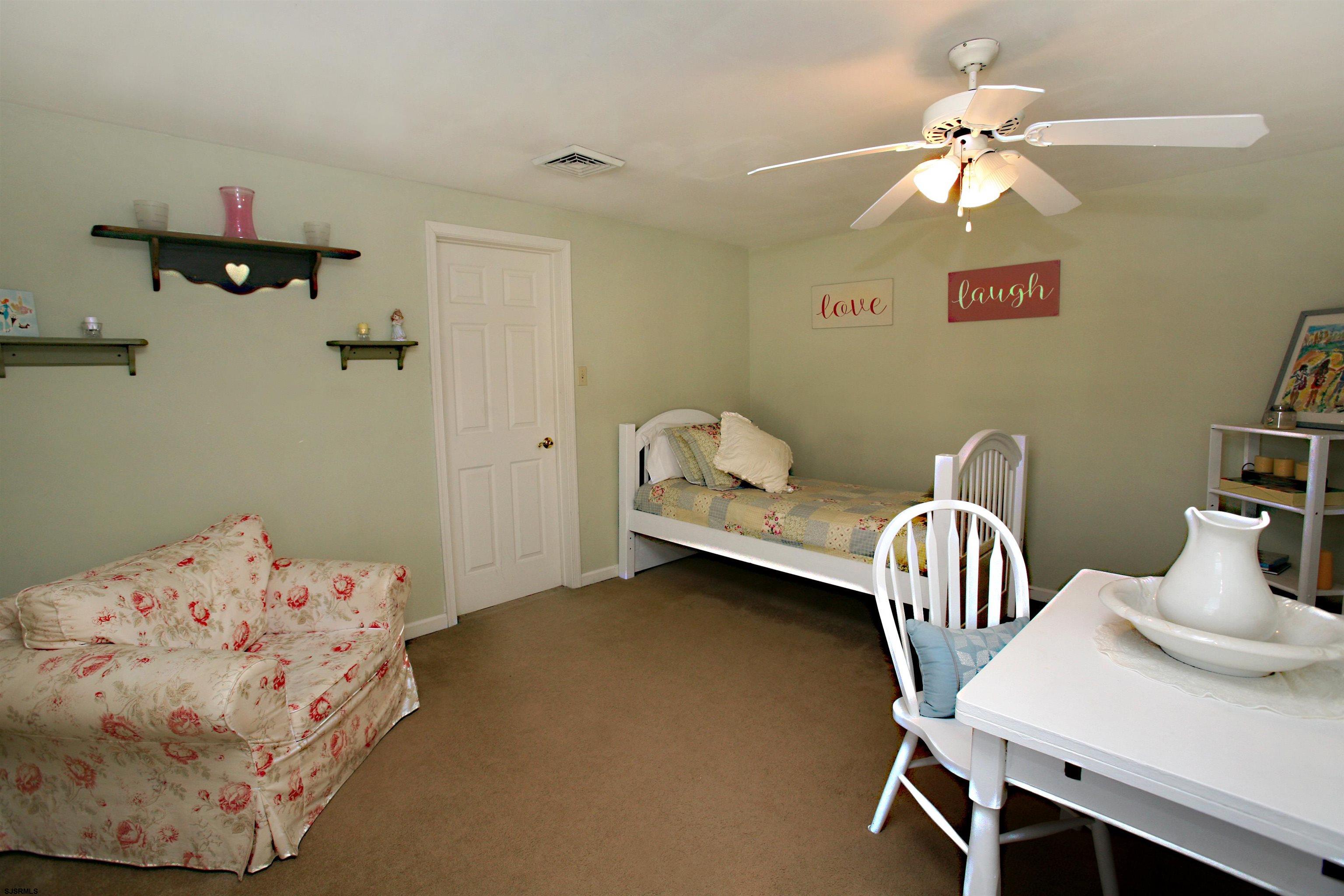 556 Grape Street Hammonton, NJ 08037 - Photo 20 of 26 a bedroom with a bed and a chandelier